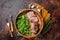 Juicy tenderloin Steak, sliced Roast beef in wooden plate with arugula. Dark background. Top view. Copy space