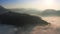 Julian Alps, Slovenia - 4K flying above the clouds around a hilltop in Triglav National Park over Julian Alps at sunrise