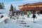 Julius Romer Hutte / Postavaru hut with skiers and snowboarders moving around on the outside terrace.