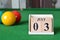 July 03, number cube with balls on snooker table, sport background.