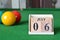 July 06, number cube with balls on snooker table, sport background.