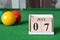 July 07, number cube with balls on snooker table, sport background.