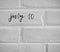 July 10 WRITTEN ON WHITE PLAIN BRICK WALL