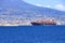 July 11 2021 Napoli in Italy in Europe: A picture of the city of Naples with a cargo ship in the gulf
