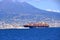 July 11 2021 Napoli in Italy in Europe: A picture of the city of Naples with a cargo ship in the gulf