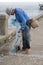 July 12 2017 - Chantaburi ,Thailand - Old Fishermen clearing fisherman net , a lot of small fish