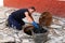 July 13, 2020. Granada. Spain: Worker cleans the drains hatch and removes dirt and debris from the sewer. Plumber cleans the sewer