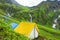 July 14th 2022, Himachal Pradesh India. Multiple colorful tents at Bheem Dwari base camp with beautiful mountains peaks and