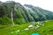 July 14th 2022, Himachal Pradesh India. Multiple colorful tents at Bheem Dwari base camp with beautiful mountains peaks and