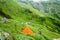 July 14th 2022, Himachal Pradesh India. Multiple colorful tents at Bheem Dwari base camp with beautiful mountains peaks and