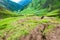 July 14th 2022, Himachal Pradesh India. People with a walking stick trekking down to Parvati bagh valley during Shrikhand Mahadev