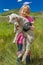 July 17, 2016 - Little girl holds sheep on Hastings Mesa near Ridgway, Colorado from truck