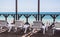 July 18 2018 Sochi city view through a wooden terrace with sun loungers on the blue calm sea