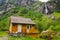 July 20, 2019. Norway. Flam. Rural house near waterfall and mountain in flam city northern norway. House and waterfall