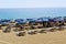 July, 2017 - People rest on deckchairs in the shade of beach umbrellas on Cleopatra Beach Alanya, Turkey