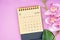 The July 2023 calendar desk and pink orchid on pink background