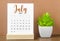 The July 2023 Monthly calendar for 2023 year on wooden table