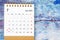 The July 2023 Monthly desk calendar for 2023 year on old blue wooden background
