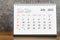 The July 2023 Monthly desk calendar for 2023 year on wooden table