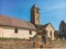 July 21, 2017. France. Region Burgundy. An old stone church with a tower, a bell tower on which is a cross and a rooster, next to