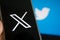 July 25, 2023, Russia. The logo in the form of the letter X displayed on the smartphone. Twitter rebranding, and
