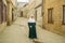 July 29, 2023. Russia, Republic of Dagestan, Derbent, a Muslim woman in a green dress and a white khimar on the street