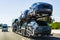 July 4, 2019 Redwood City / CA / USA - Car transporter carries Tesla Model 3 new vehicles along the highway in San Francisco bay