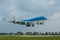 Jumbo passenger aircraft flying above a runway