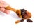 Jumbo raisins in wooden spoon on white