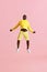 Jump. Black man jumping in air and screaming on pink background