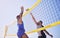 Jump, hit and beach, volleyball and men at net with sports action, fun and summer competition with blue sky. Energy