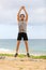 Jump Squats fitness training. Athlete Man doing Jump Squat exercise workout. Male fitness instructor training on beach