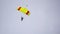 Jump with a tandem colored parachute on a blue sky with white clouds, adrenaline and risk