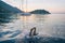 Jump to water, swimming on adriatic sea Makarska Korcula Croatia. Yacht in marina, sailing in Croatia.