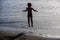 Jump. Young boy enjoys the cool surf and beaches of Spain or US. Happy child in summer. Sea mood. Happy little boy