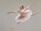 Jumping ballet dancer or ballerina performer dancing in a beautiful, elegant tutu dress or fashion design costume in