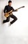 Jumping bass player on a white background