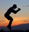 Jumping cameraman\'s silhouette.