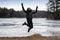 Jumping Chinese woman on beach winter