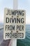 Jumping Diving From Pier Prohibited written on a sign board in Destin Florida