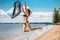 Jumping happy girl on the beach, fit sporty healthy body in bikini