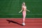 Jumping higher. athletic lady use jumping-rope on stadium. female athlete do jumping sport workout. trainer or coach