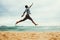 Jumping latin guy at beach