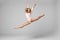 Jumping professional gymnast girl dancer isolated on studio background