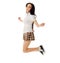 Jumping school girl in plaid skirt and sneakers