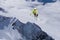 A jumping skier in the mountains. Mountain ski, winter extreme sport.