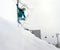 Jumping snowboarder in mountains