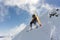 A jumping snowboarder in the mountains. Snowboarding, winter extreme sport.