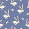 Jumping white rabbits with long ears and playing card on a blue background. Bunny in wonderland seamless pattern.