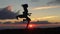 Jumping woman and sunset silhouette. Girl movement over sunset light. Free young woman at golden sunset. Freedom and